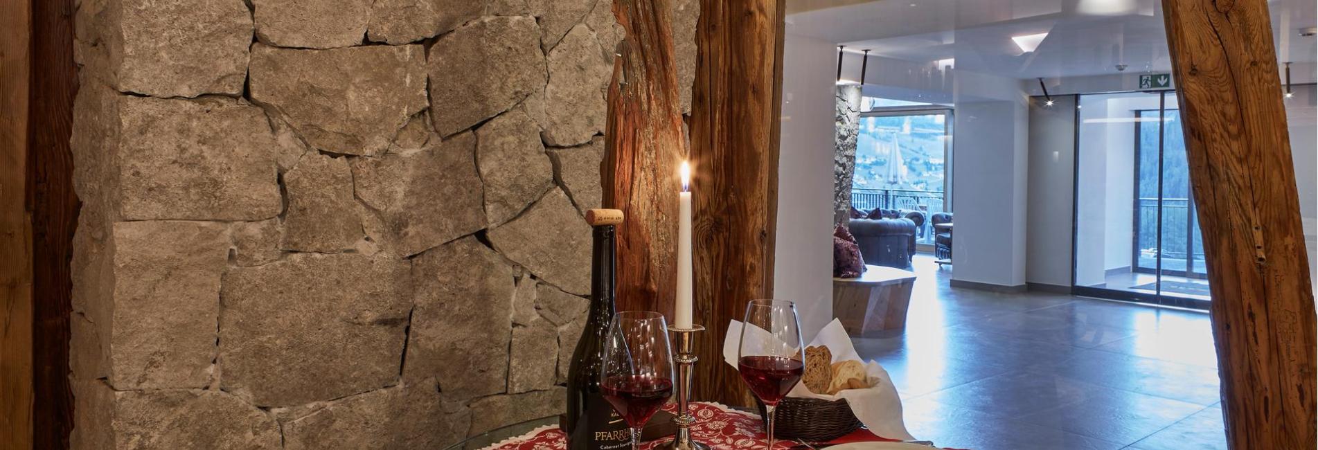 A set table with red wine and a traditional South Tyrolean “Brettljause.”